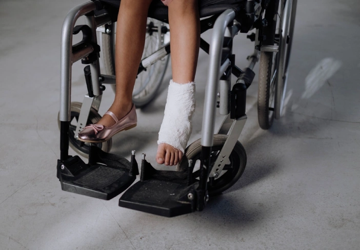 Woman in White Socks Sitting on Black and Gray Exercise Equipment