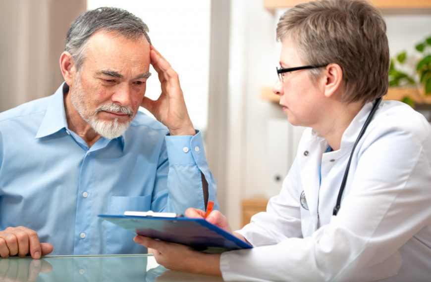 elderly man being diagnosed by a doctor