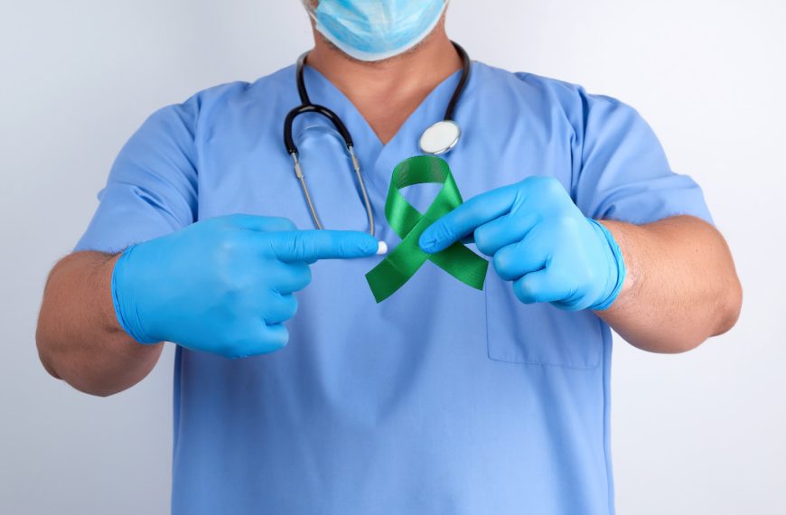 medical practitioner pointing to a green ribbon representing lyme disease